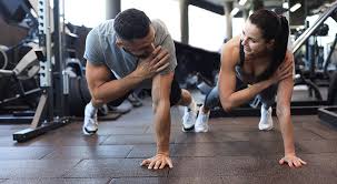 Image of man and woman doing Cardio Coalville to tone their arms. 